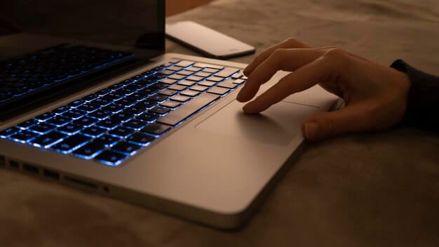 A close-up view of a person's hands typing rapidly on a laptop keyboard, illuminated by the screen. The background is blurred, focusing on the hands and keyboard, symbolizing the rush to buy tickets online.