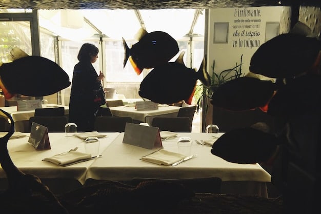 A behind-the-scenes photo of a meeting room, with representatives from a K-Pop agency and a US television network discussing contract terms and scheduling details, showcasing the professionalism and seriousness of the negotiations.