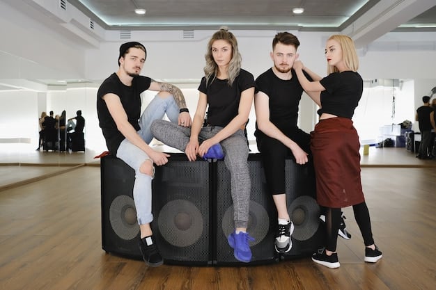A candid shot of K-Pop trainees rehearsing a complex dance routine in a spacious studio with large windows showing the Hollywood Hills in the background. The lighting is natural, highlighting the sweat and determination on their faces.