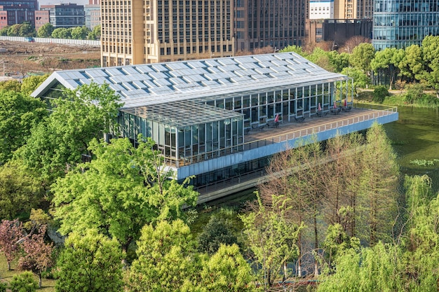 A modern, eco-friendly building with solar panels and green landscaping. The building showcases sustainable architectural design and energy-efficient features.