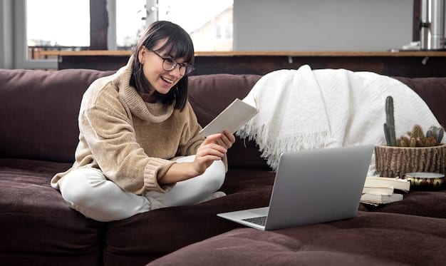 A person sitting on a couch in a cozy living room, with a laptop displaying a K-drama episode and Korean language learning materials (textbook, notebook) beside them.