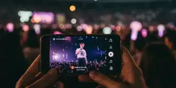 K-Pop Fandom Evolution: 2025 US Fan Engagement Trends K-Pop fan watching a live concert stream on a smartphone, blending virtual and in-person fan experiences.
