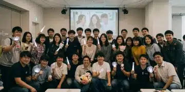 Enthusiastic dorama fans gathered around a screen, enjoying a fan meeting in 2026